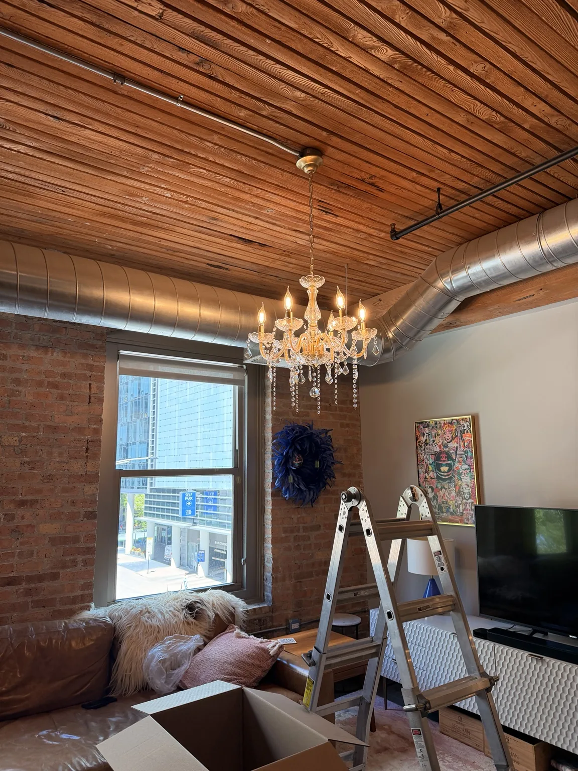 Fully illuminated statement chandelier installed in a Chicago loft
