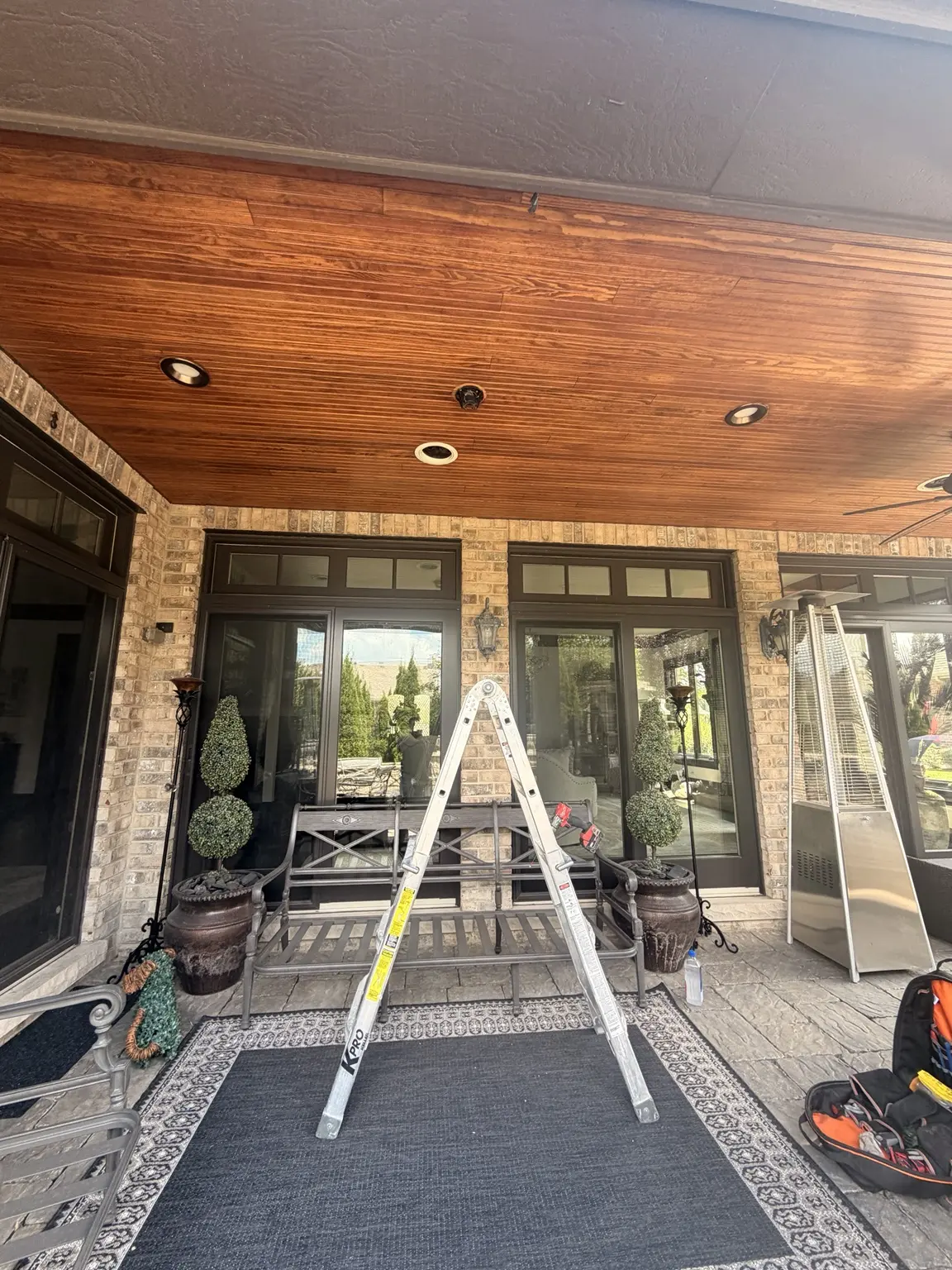 Covered wood patio ceiling and protected work area before both fans were installed