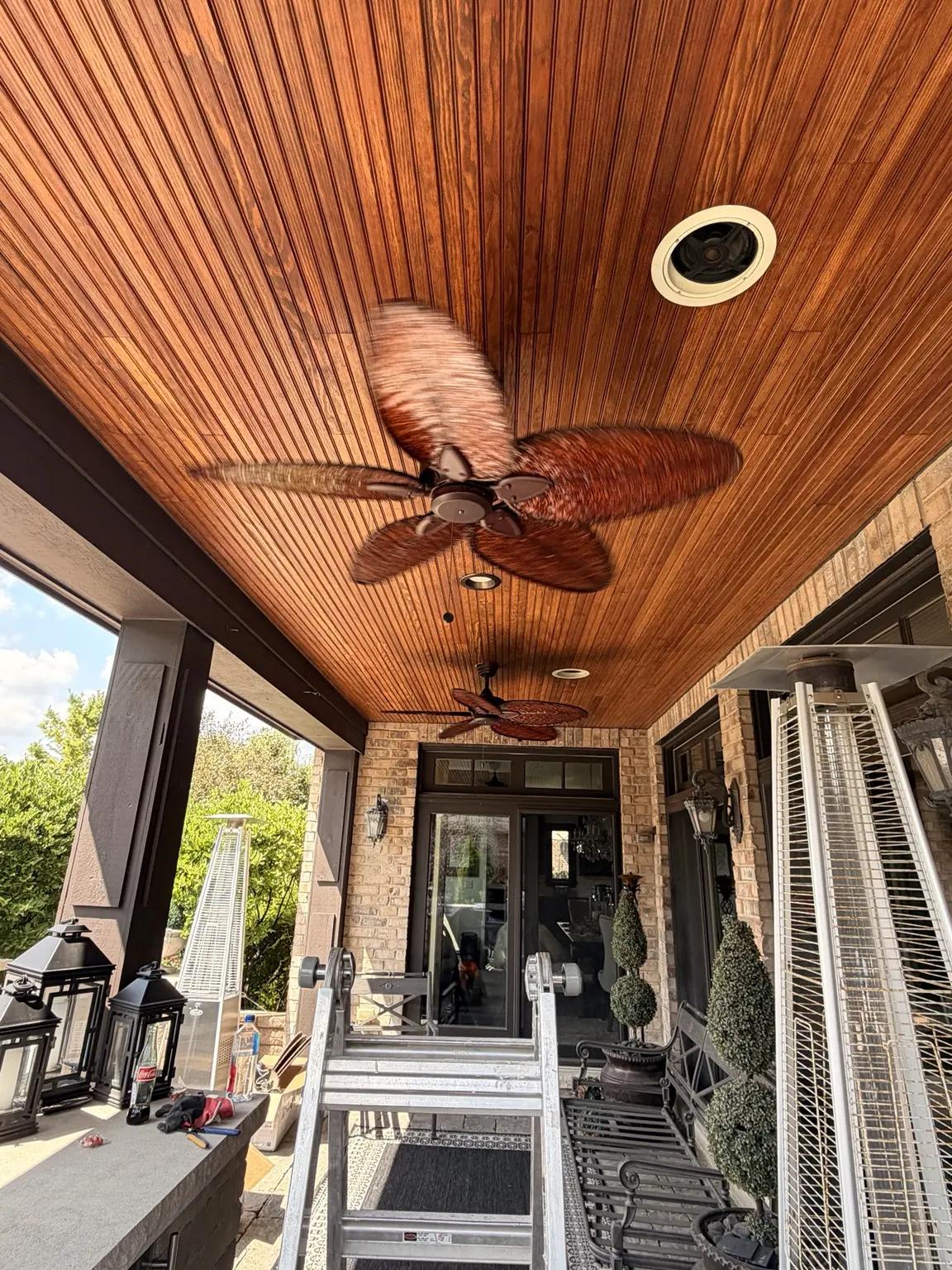 Closer finished view of both decorative ceiling fans beneath the wood patio ceiling