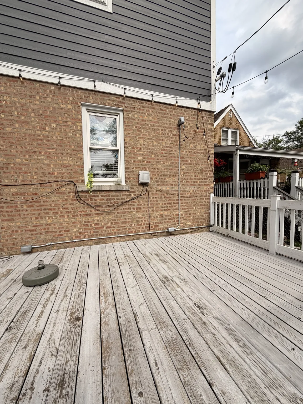 Completed exterior conduit and electrical boxes routed across a Chicago deck
