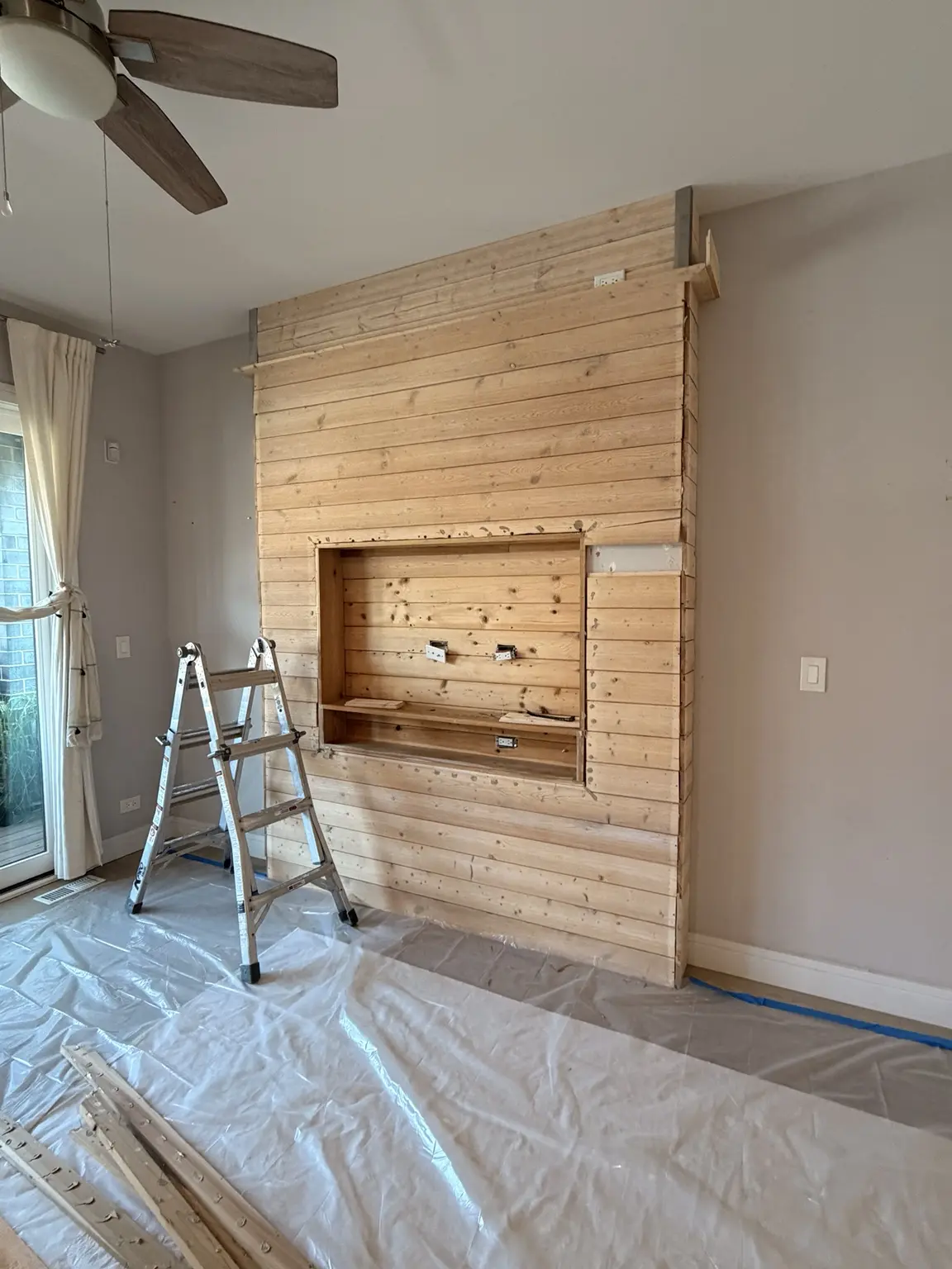 Large wood feature wall with built-in opening before removal