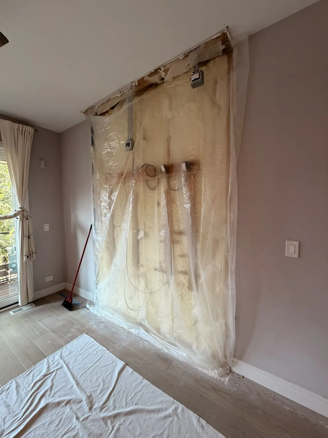Feature wall opened after wood removal with existing electrical boxes and wiring visible