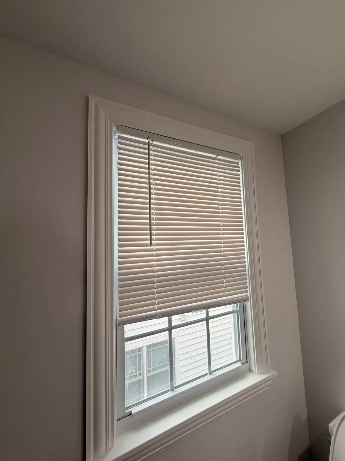 Finished interior window trim with installed blinds