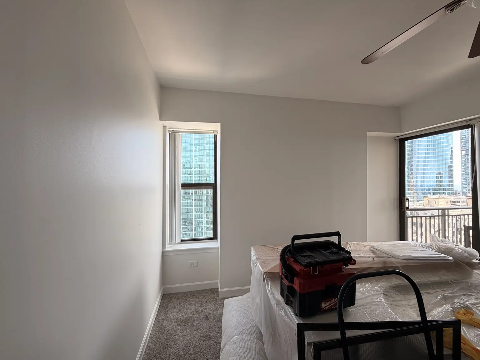 Freshly painted downtown condo room with protected furniture